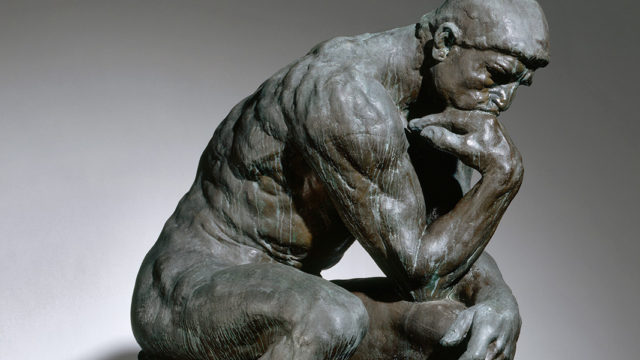 Rodin's s "The Thinker," bronze sculpture of man sitting and resting chin in hand, deep in thought