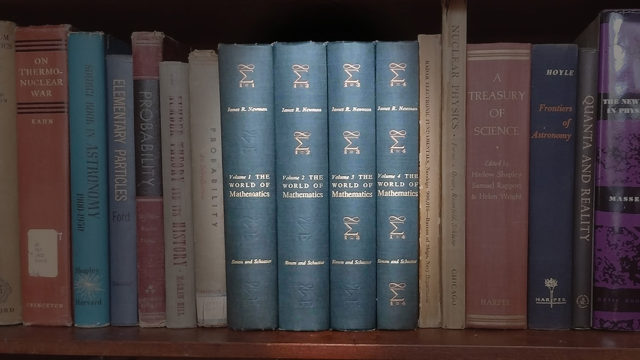 bookshelf with The World of Mathematics highlighted