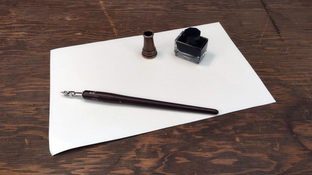 Artist's pen and inkwell on sheet of drawing paper